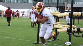 Helu working with group on one of the machines - Training Camp 2014